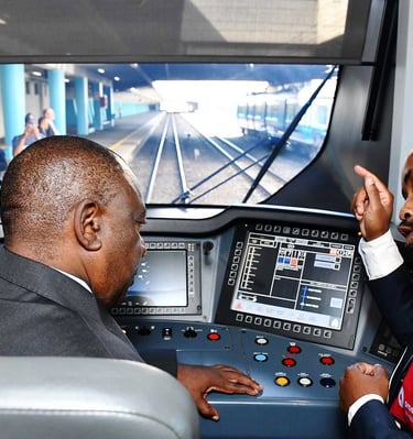 two men in suits and ties are looking at a train