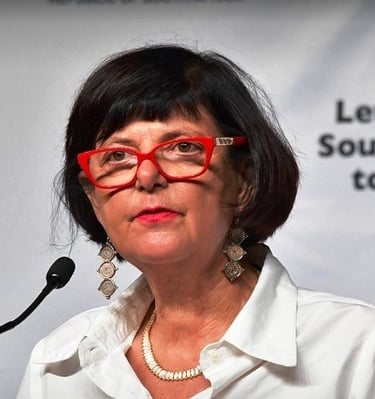 a woman in glasses and a white shirt