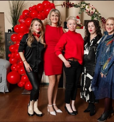 a group of women standing in front of a balloon - shaped balloon