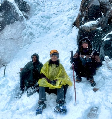 Travel advisor in the snow while climbing a glacier during a winter mountain expedition in Peru.