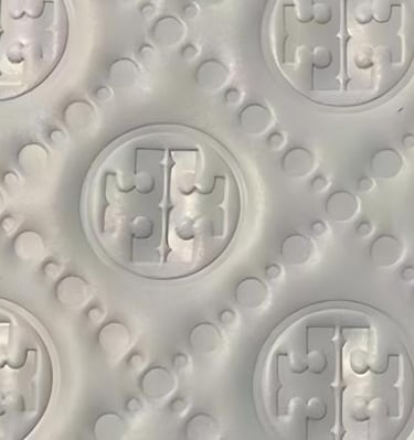 Detailed debossed pattern on material, creating a subtle and tactile finish by King Fly.