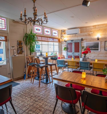 a restaurant with a table and chairs and a chandelier