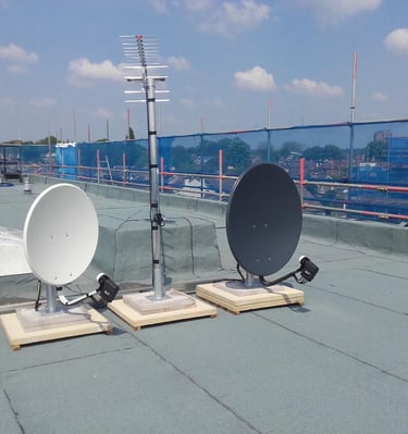 Rooftop TV aerial and dual satellite dish