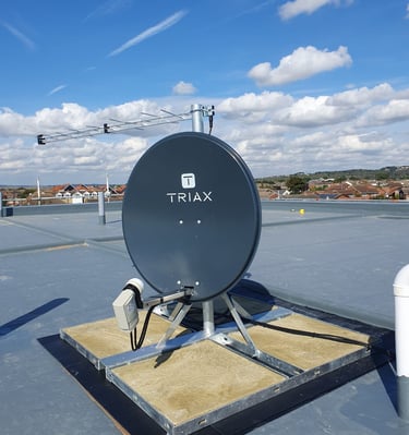 Triax satellite dish professionally installed on flat rooftop