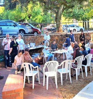 a group of people sitting at tables in a park - Stirk Park Kalamunda