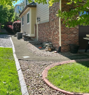 A sleek 3.5-foot grey breeze walkway with galvanized edgingand an integrated French drain system.