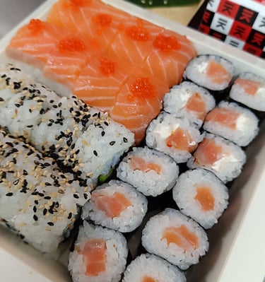 a box of sushi with salmon and avocado
