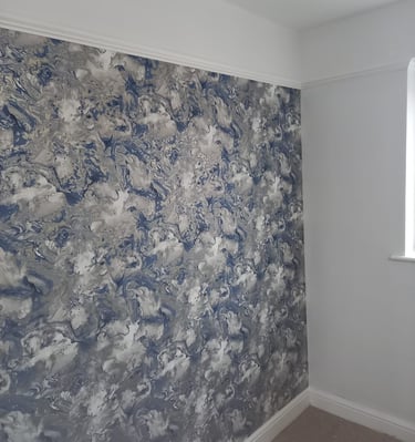 a room with a seaspray wallpapered wall