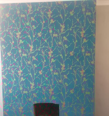 a fireplace with turquoise wallpaper