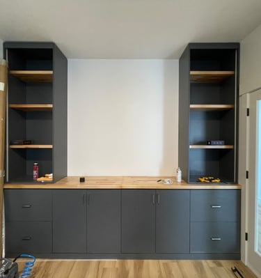 Custom-built storage unit by Portugal Woodworks in Utah, with a mix of open shelves and cabinets.