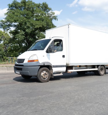 a white truck with a white boxy truck behind it