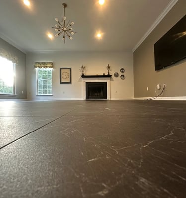 a living room with a fireplace, and newly installed vinyl tile