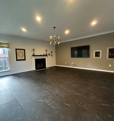 a living room with a fireplace and vinyl tile