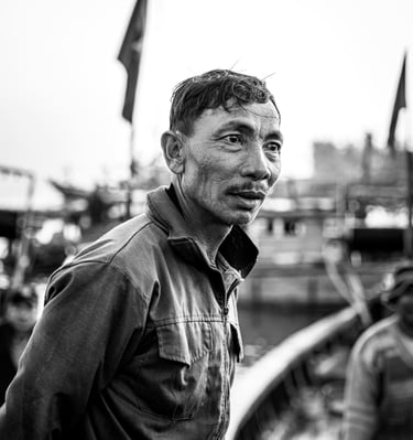 a black and white image of a fisherman in Vietnam