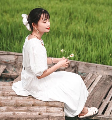 a photo of a young vietnamese woman in a rice field