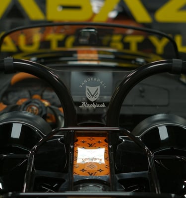 Vanderhall Blackjack autocycle interior with custom orange Louis Vuitton monogram wrap and roll bars.