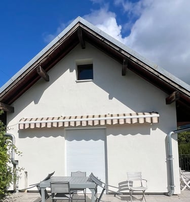 a house with a table and chairs outside