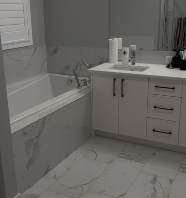 a bathroom with a marbled floor and a tub