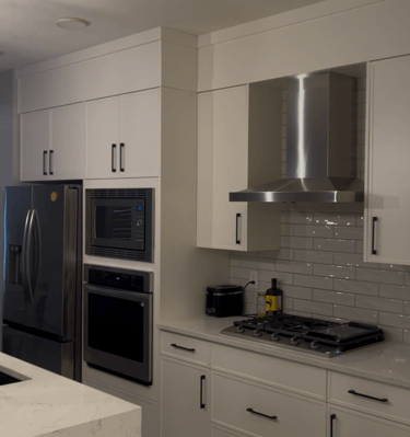 a kitchen with a large white counter top