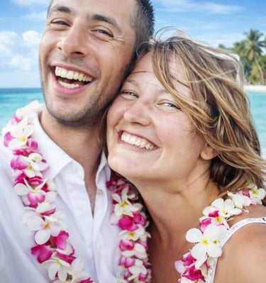 a man and woman standing in front of a beach in Carribean