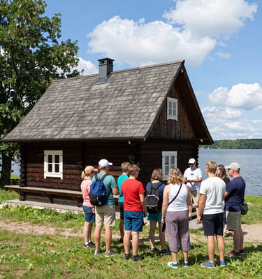 A group of visitors listening attentively during an educational tour inside the cozy 65 sqm house.