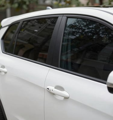Close-up of a sleek car window tinted perfectly under bright sunlight.
