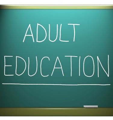 image of a chalkboard with Adult Education written on it