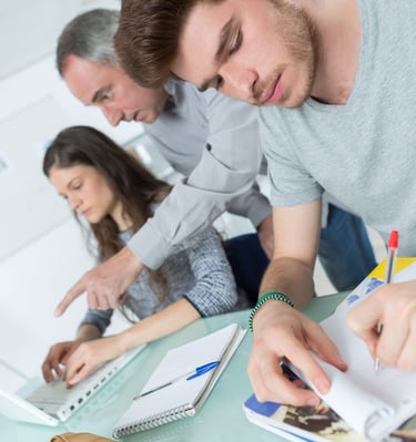 image of three adults studying