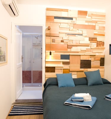 Comfortable bed in a Rome holiday apartment at Studio Paolina 2