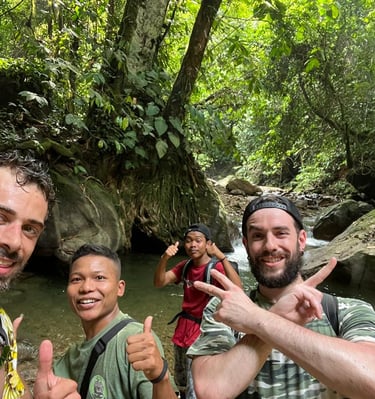 Group of ethical trekkers hiking through the dense jungle of Gunung Leuser National Park, guided by 