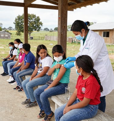 Children receiving health education materials in a local school setting.