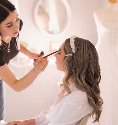 Bride getting her makeup touched up before the ceremony — candid Toronto wedding morning moment