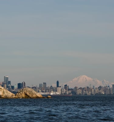 Point Atkinson Lighthouse overlooking the Vancouver skyline and Mount Baker on a clear day.