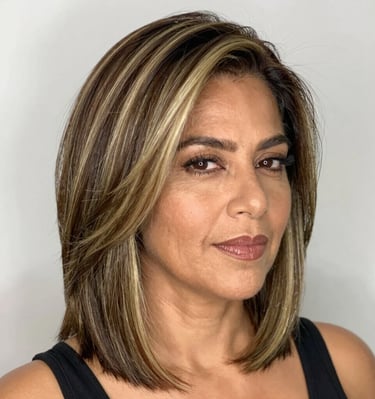 Side profile of a client with long, flowing sisterlocks cascading over a vibrant patterned scarf.