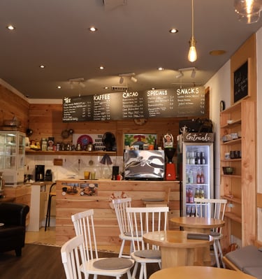 a cafe with a small table and chairs