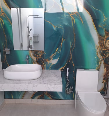 Modern bathroom featuring a white vessel sink, marble countertop, and emerald green marble effect wall panels.