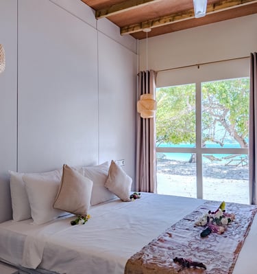 Modern beachfront bedroom at a boutique guest house in Maalhos, Baa Atoll, Maldives, featuring ocean