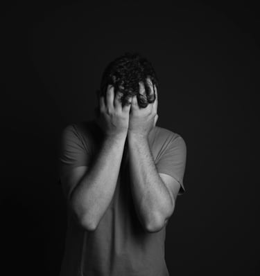 a man holding his hands up to his face