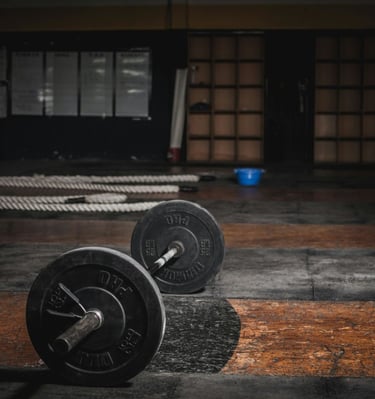 two black and white weights on a gym floor