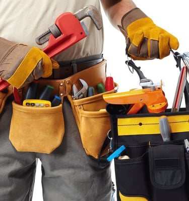 Professional plumber with full tool belt and kit ready for work