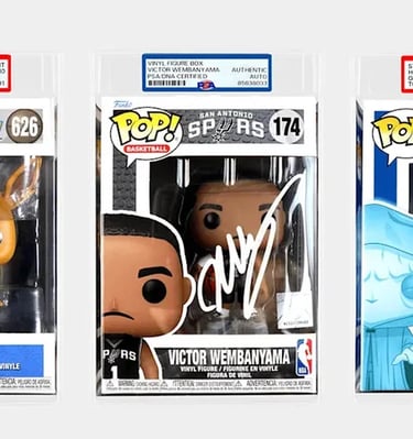 Three PSA graded Funko Pop figures featuring Eevee, Victor Wembanyama, and Holographic Emperor.