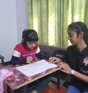 a home tutor from gharpadh sitting on a couch with a child