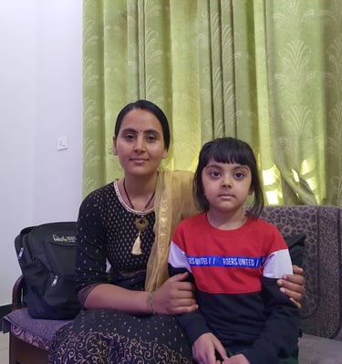 a woman sitting on a couch with her daughter