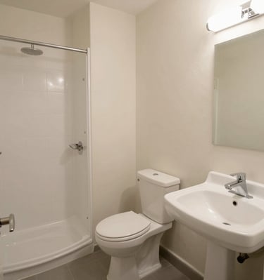 Bathroom with bright tiles, shower, and fresh towels neatly arranged.