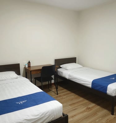 Cozy employee room with modern furnishings and a large window letting in natural light.