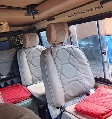 Interior of a safari tour vehicle with reclining, comfortable seats 