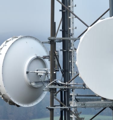 Close-up of microwave point-to-point radio link antennas on a telecommunications tower.