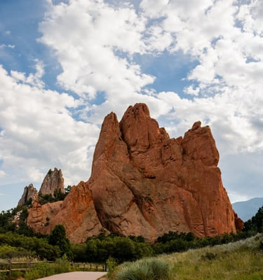 a paved path with a paved path leading to a mountain, Garden of the Gods