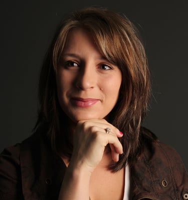a woman with a brown jacket and a white shirt