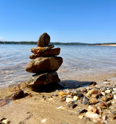 a stack of rocks sitting on the beach